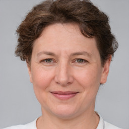 Joyful white adult female with short  brown hair and grey eyes