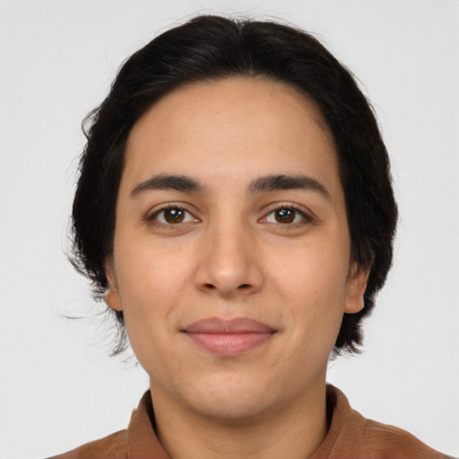 Joyful latino young-adult female with short  brown hair and brown eyes