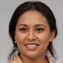 Joyful latino young-adult female with medium  brown hair and brown eyes