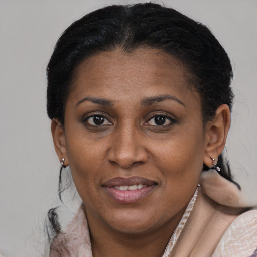 Joyful black adult female with short  brown hair and brown eyes