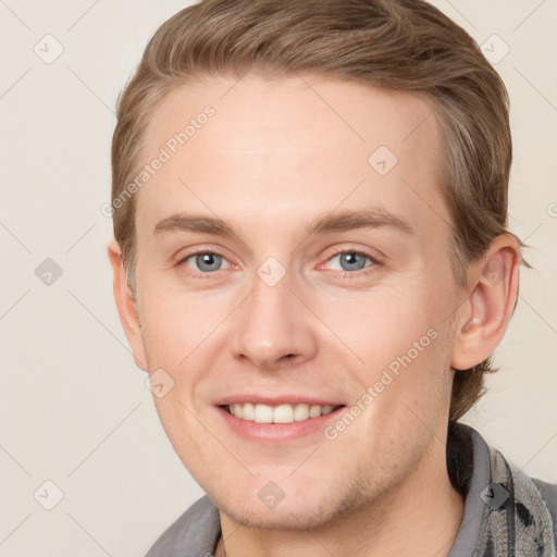 Joyful white young-adult male with short  brown hair and blue eyes