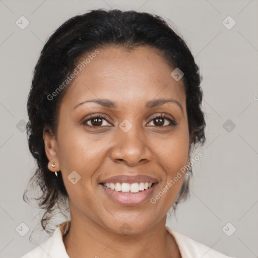 Joyful black adult female with medium  brown hair and brown eyes