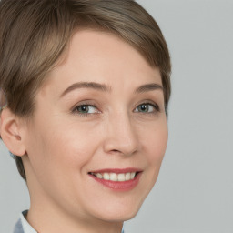 Joyful white young-adult female with short  brown hair and grey eyes