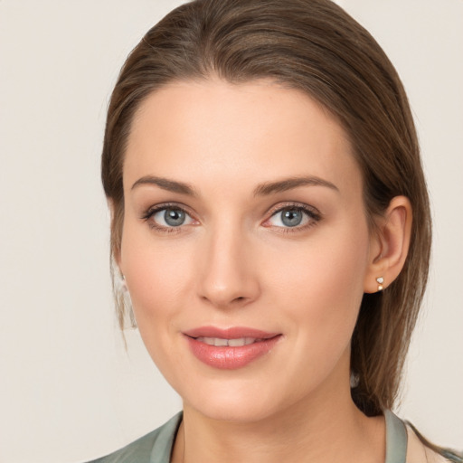 Joyful white young-adult female with medium  brown hair and grey eyes