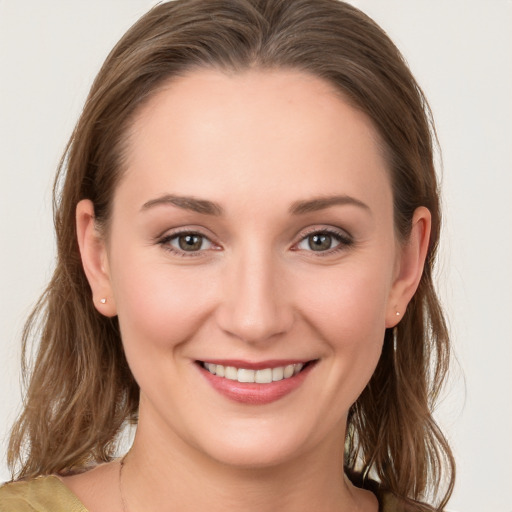 Joyful white young-adult female with long  brown hair and grey eyes