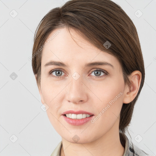 Joyful white young-adult female with medium  brown hair and grey eyes