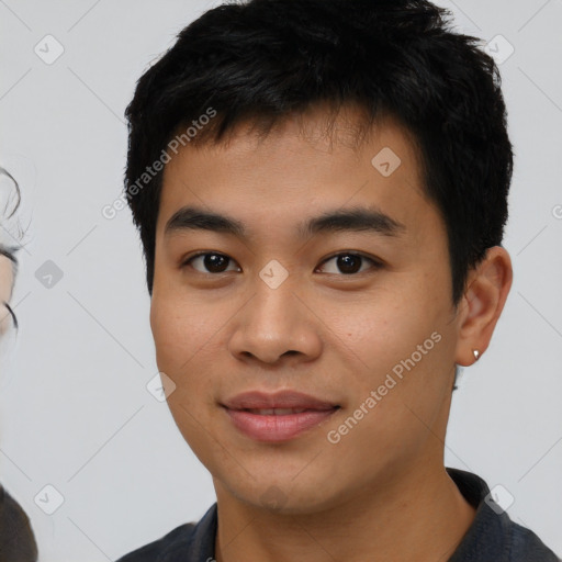 Joyful asian young-adult male with short  black hair and brown eyes