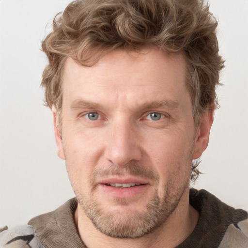 Joyful white adult male with short  brown hair and grey eyes