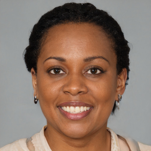 Joyful black young-adult female with short  brown hair and brown eyes