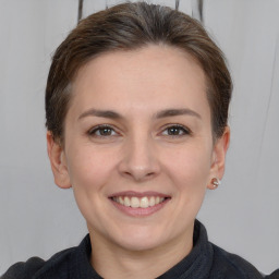 Joyful white young-adult female with medium  brown hair and grey eyes