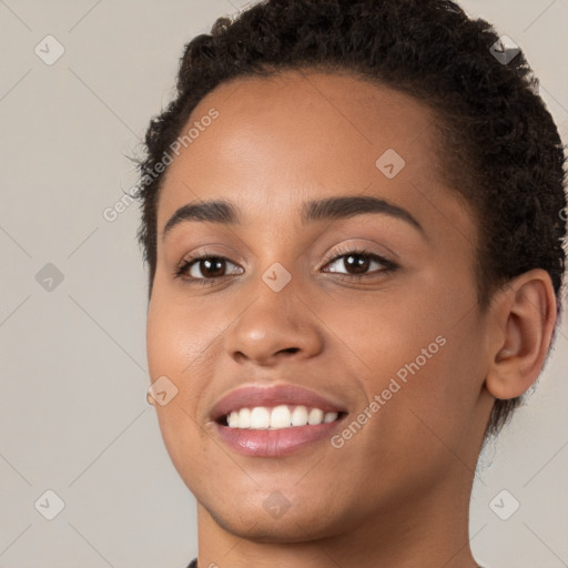 Joyful white young-adult female with short  brown hair and brown eyes