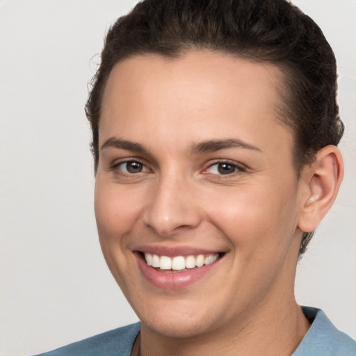 Joyful white young-adult female with short  brown hair and brown eyes