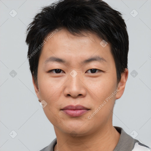 Joyful asian young-adult male with short  black hair and brown eyes