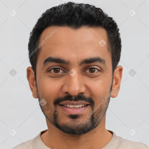 Joyful latino young-adult male with short  black hair and brown eyes