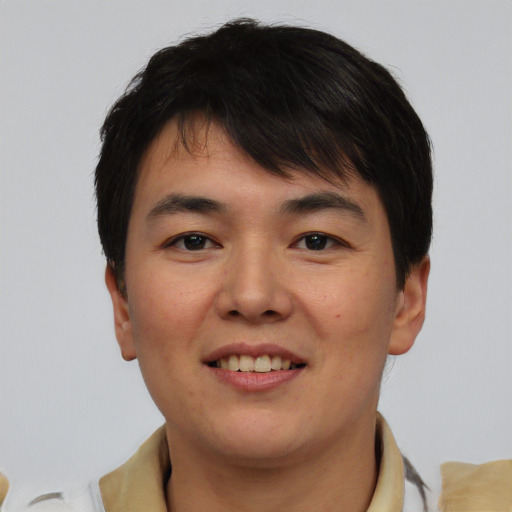 Joyful asian young-adult male with short  brown hair and brown eyes