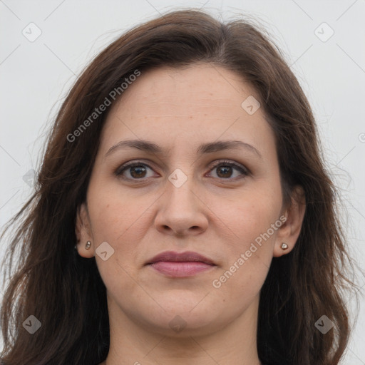 Joyful white adult female with long  brown hair and brown eyes