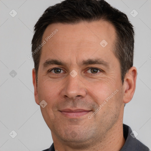 Joyful white adult male with short  brown hair and brown eyes