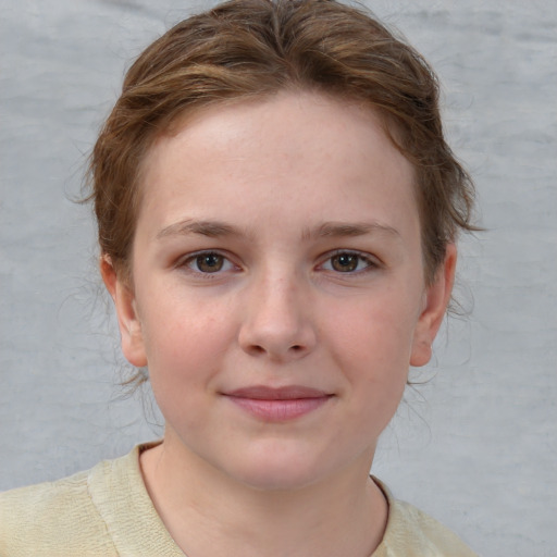 Joyful white child female with short  brown hair and blue eyes