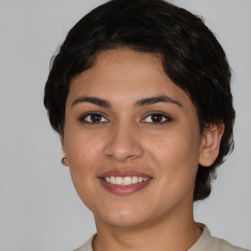 Joyful white young-adult female with short  black hair and brown eyes