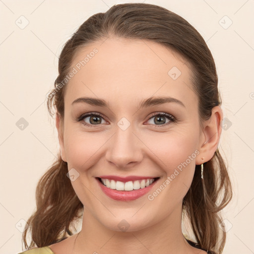 Joyful white young-adult female with long  brown hair and blue eyes