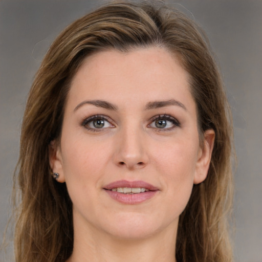 Joyful white young-adult female with long  brown hair and grey eyes