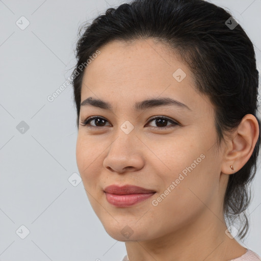 Joyful latino young-adult female with medium  brown hair and brown eyes