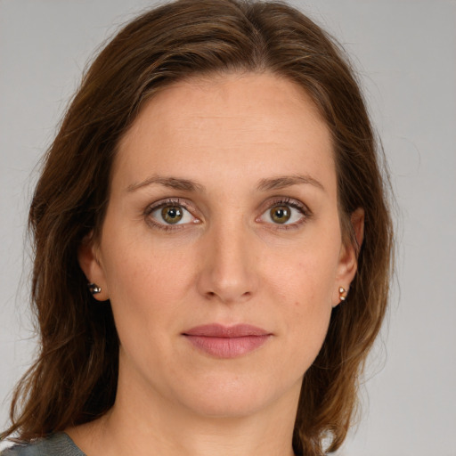 Joyful white young-adult female with medium  brown hair and green eyes