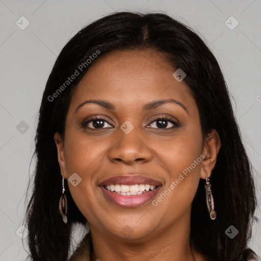 Joyful black adult female with long  brown hair and brown eyes