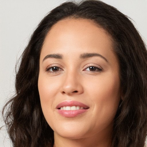 Joyful white young-adult female with long  brown hair and brown eyes