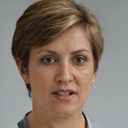 Joyful white adult female with short  brown hair and grey eyes