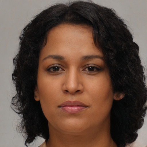 Neutral black young-adult female with long  brown hair and brown eyes