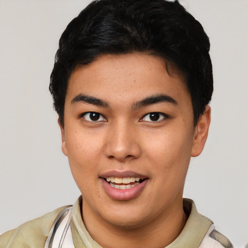 Joyful latino young-adult male with short  black hair and brown eyes