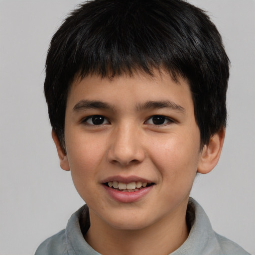 Joyful asian child male with short  brown hair and brown eyes