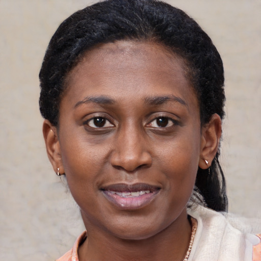 Joyful black young-adult female with short  brown hair and brown eyes