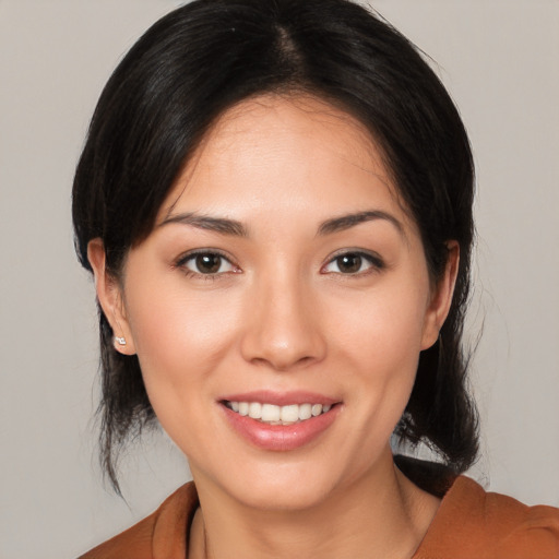 Joyful white young-adult female with medium  brown hair and brown eyes