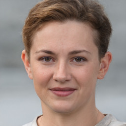 Joyful white young-adult female with short  brown hair and grey eyes