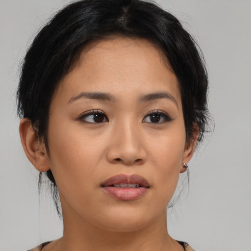Joyful asian young-adult female with medium  brown hair and brown eyes