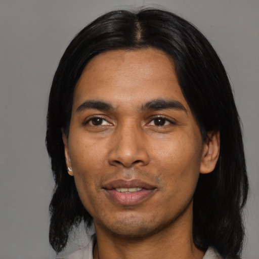 Joyful asian young-adult male with medium  black hair and brown eyes
