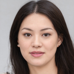 Joyful asian young-adult female with long  brown hair and brown eyes