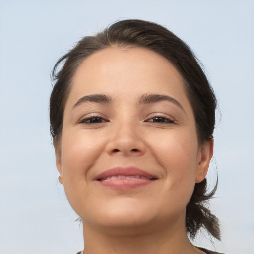 Joyful white young-adult female with medium  brown hair and brown eyes