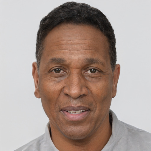 Joyful black adult male with short  black hair and brown eyes