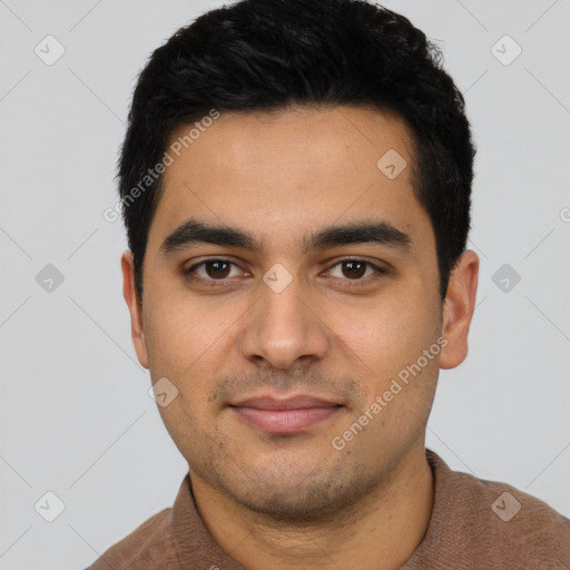 Joyful latino young-adult male with short  black hair and brown eyes