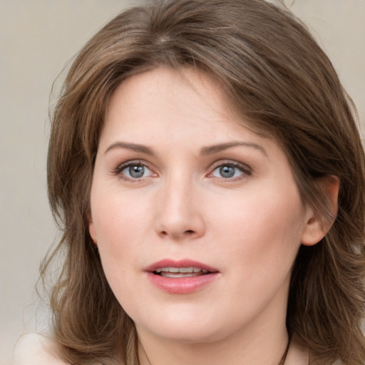 Joyful white young-adult female with medium  brown hair and blue eyes