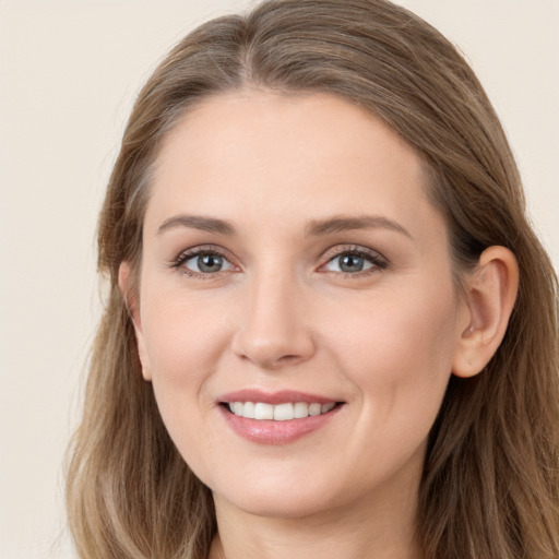 Joyful white young-adult female with long  brown hair and grey eyes