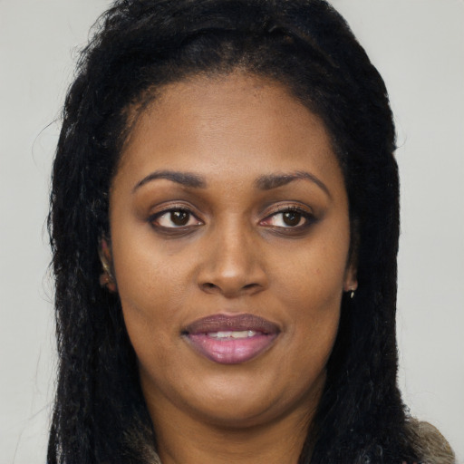 Joyful latino young-adult female with long  brown hair and brown eyes