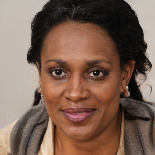 Joyful black adult female with medium  black hair and brown eyes