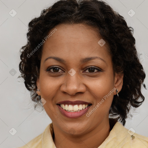 Joyful black adult female with medium  brown hair and brown eyes