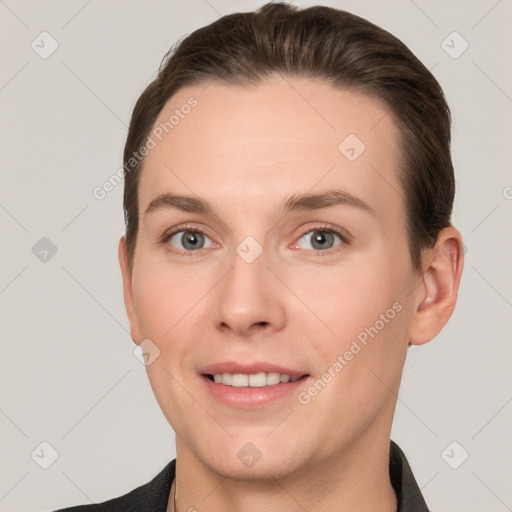 Joyful white young-adult female with short  brown hair and grey eyes