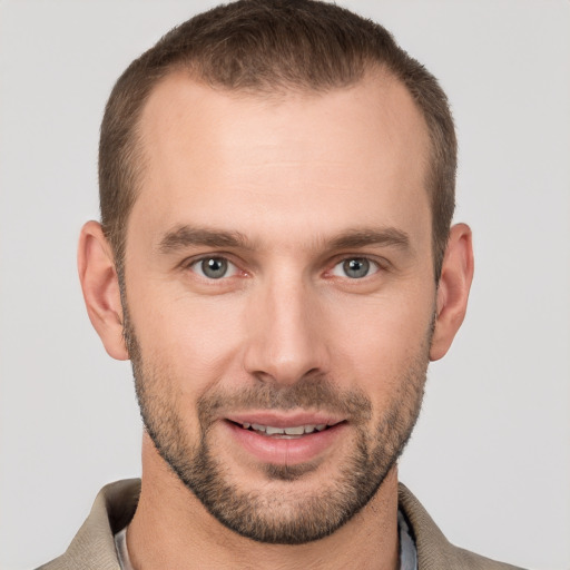 Joyful white young-adult male with short  brown hair and grey eyes