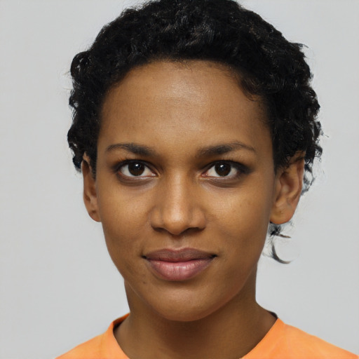 Joyful black young-adult female with short  black hair and brown eyes